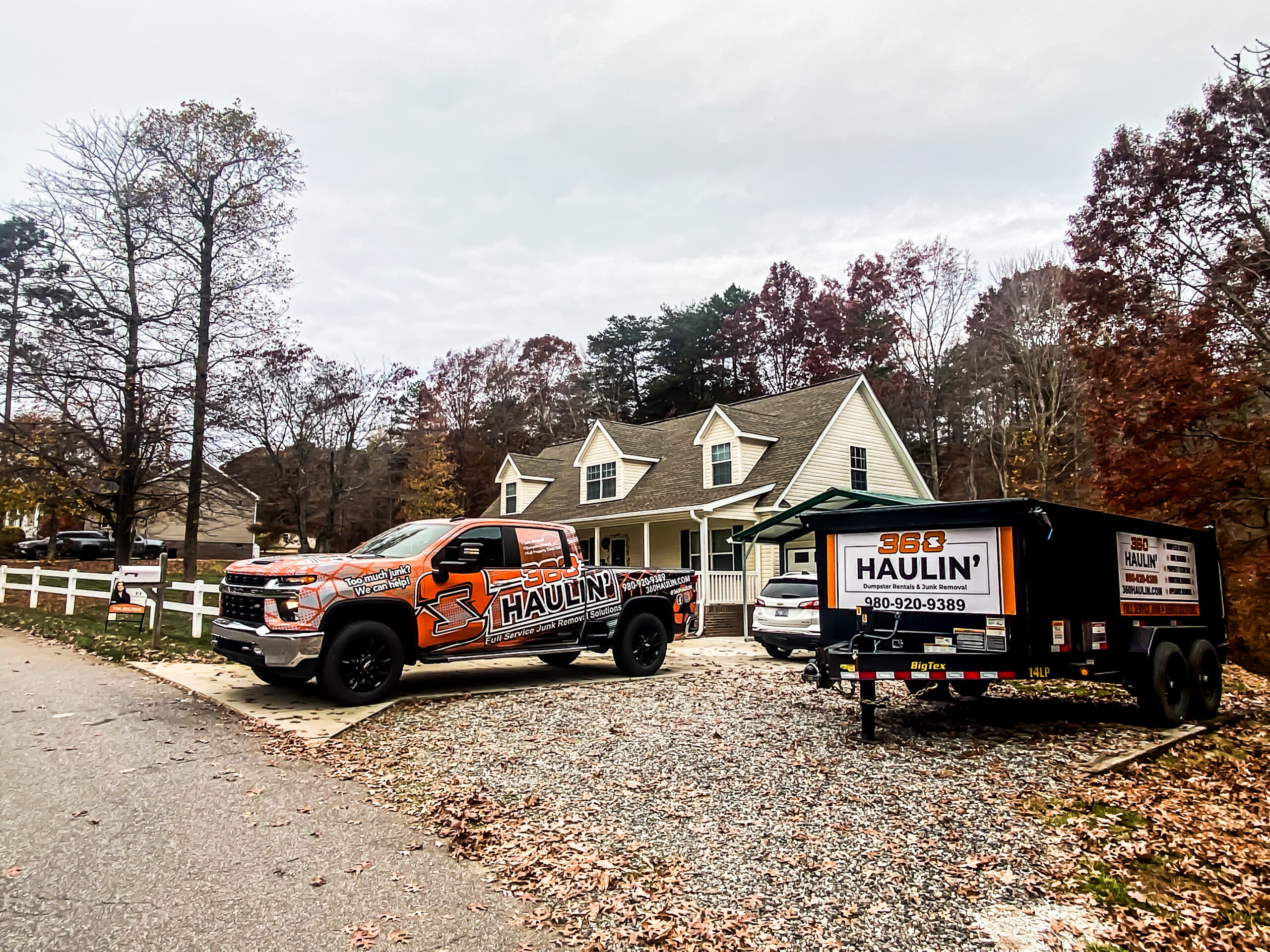 360 Haulin' truck and dumpster trailer on a residential driveway