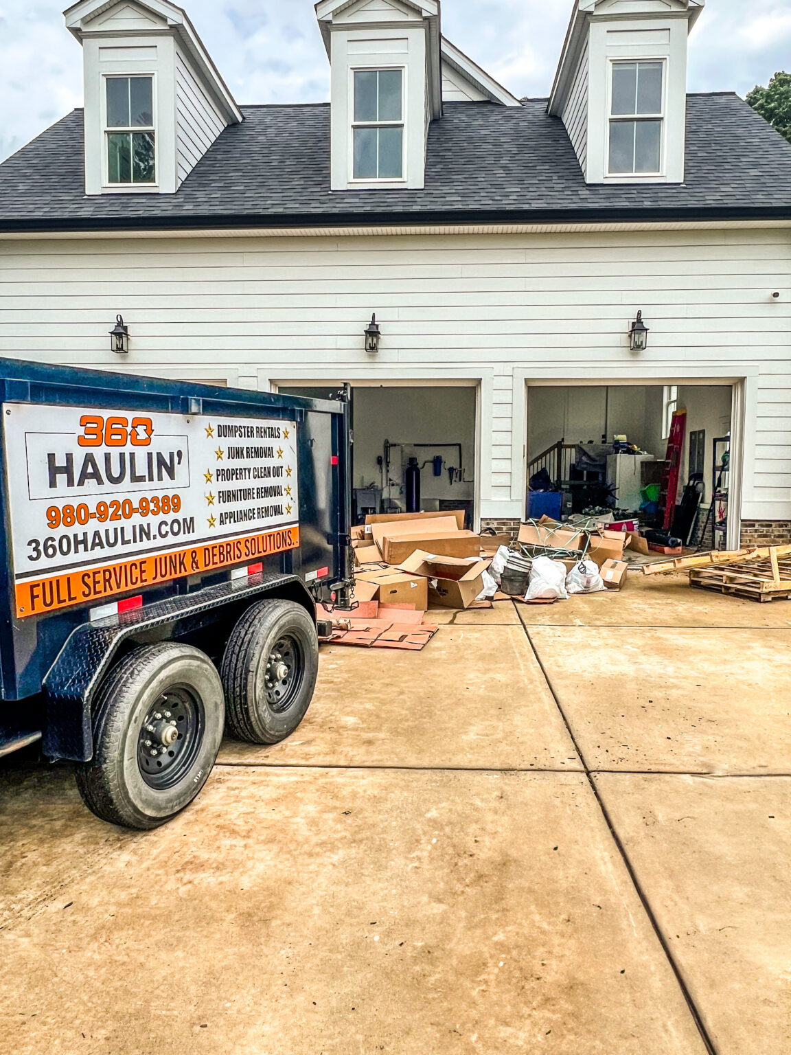 360 Haulin' dumpster trailer staged for a garage cleanout
